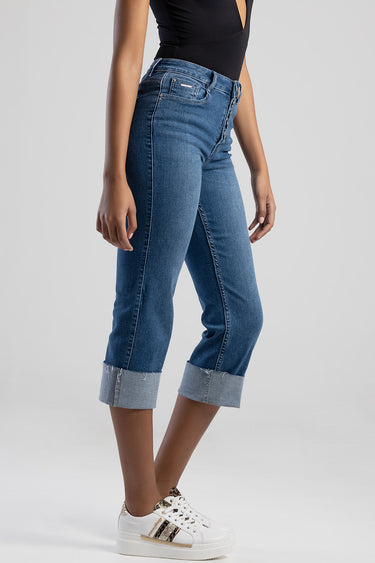 blue denim skinny jeans with a rolled cuff displayed on a model