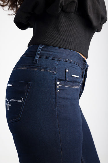 Blue Jean Traders dark indigo skinny jeans with back pocket embroidery and metal studs on a model