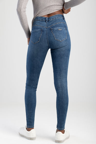 back view of blue skinny jeans by Blue Jean Traders with two back pockets, small brand tag, paired with a cropped grey knit