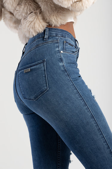 woman in blue denim jeans, side view showing back pocket and belt loops