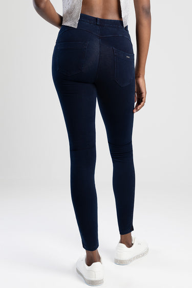 woman wearing navy blue knit jeggings from blue jean traders, back view with two pockets and slim fit, white sneakers