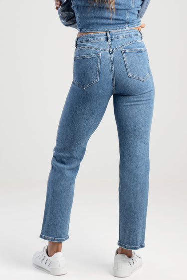 rear view of Blue Jean Traders straight jeans on a model, light wash denim with two back pockets and white sneakers