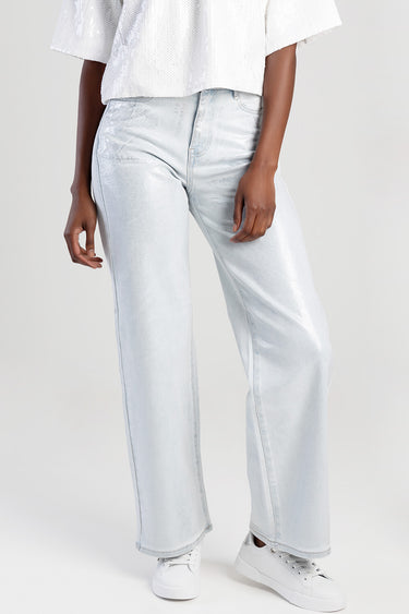 Blue Jean Traders light blue wide leg jeans with a subtle metallic sheen and white sneakers