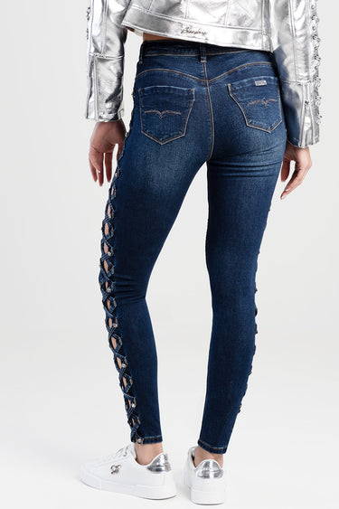 back view of dark blue skinny jeans with lace up side panels and back pockets