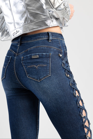 blue skinny jeans with lattice side panels and metal rivet back pocket stitching