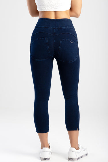 Blue Jean Traders capri jeans worn by a model, back view shows curved pockets and a small logo, with white sneakers
