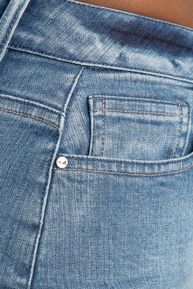 Blue Jean Traders jeans back pocket close up with metal rivet and orange stitching