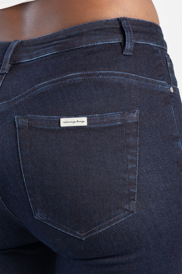 dark blue denim jeans close up of rear pocket with a small metal brand tab