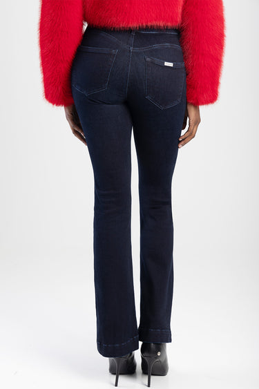 back view of dark wash bootcut jeans by Blue Jean Traders with two back pockets and a small label, paired with a red fluffy