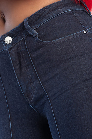 blue jean traders jeans in dark indigo denim, close up of front pocket, belt loop, and metal rivet with logo