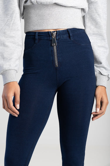 dark blue high waist jeans with a front metal zipper detail, paired with a grey cropped sweater