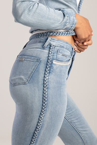 light blue jeans with a braided belt tied at the waist, back pocket visible