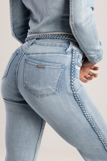 back view of light blue denim jeans with a braided belt and side chain, metal tag on the back pocket reads Blue Jean Traders