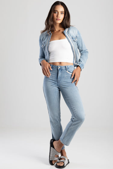 model wearing light wash straight jeans with a denim jacket and white crop top