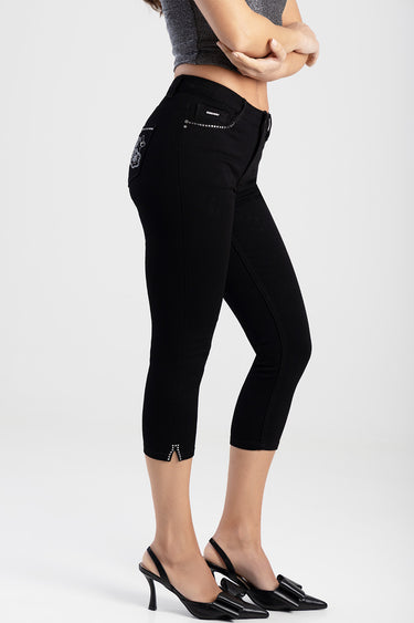 Blue Jean Traders capri jeans in black with rhinestone studs on pockets and a small hem slit, paired with a grey crop top