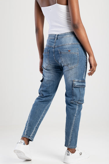 model wearing blue jean traders cargo pants with back pockets and side cargo pockets, white sneakers and a white tank top