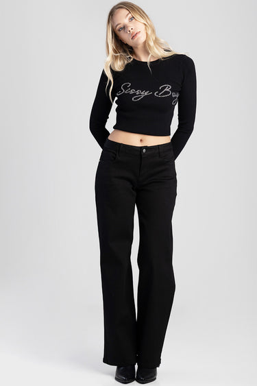woman wearing black wide leg jeans and a black knit crop top with silver script lettering