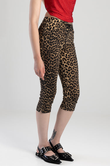 leopard print capri jeans by Blue Jean Traders with lace up front and front pockets on a model in a red top
