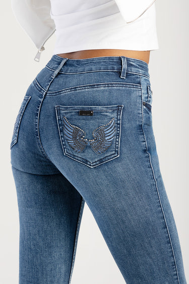 blue denim jeans shown from rear with embellished back pocket featuring wing design and studs
