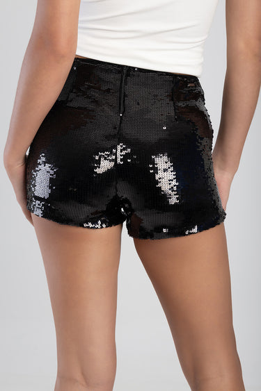 back view of a person in black sequin shorts with a center back zipper and a white sleeveless top