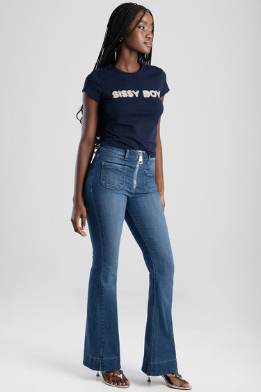 model wearing blue flare jeans by Blue Jean Traders with front zipper and patch pockets, paired with a navy short sleeve tee