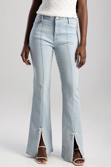 woman wearing light blue bootcut jeans with front pockets and lace trim slits at the hems by blue jean traders