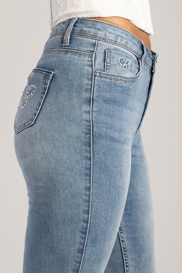 light blue skinny jeans with embroidered flower on back pocket, side view by Blue Jean Traders