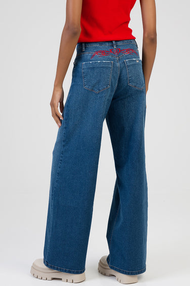 Blue Jean Traders wide leg jeans with red embroidery across the back yoke and two back pockets shown with a red top and