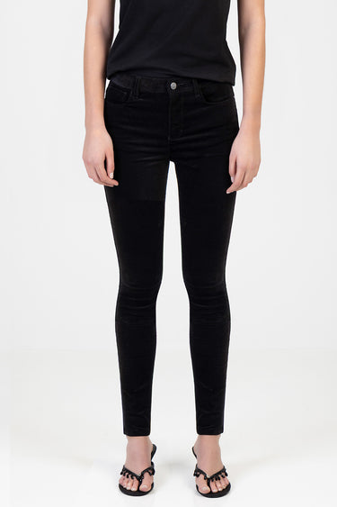 full length view of a person in black skinny pants with a high waist and front pockets, paired with a black top and black