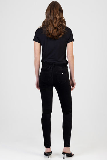 back view of a person wearing black skinny pants and a black short sleeve top in black heeled sandals