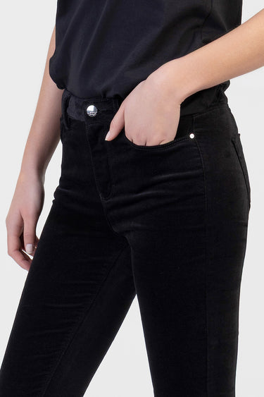 black skinny pants by blue jean traders shown with a hand in the front pocket and a silver button