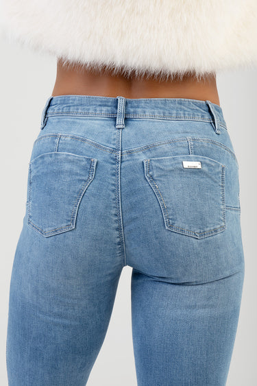 back view of light blue denim jeans with rear pockets and belt loops