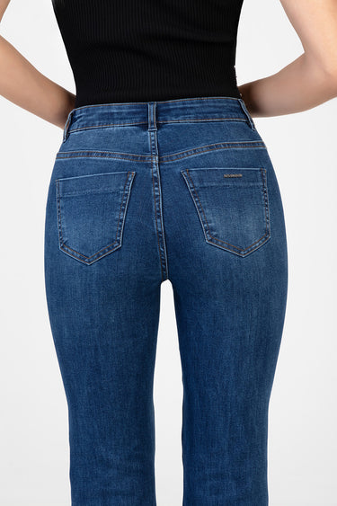 back view of a model wearing blue jeans by blue jean traders with two back pockets and contrast stitching