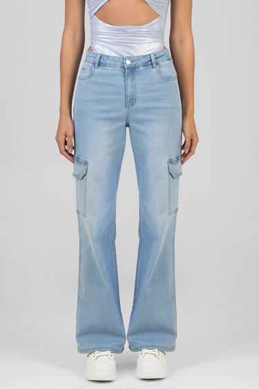 model wearing light wash wide leg jeans with cargo pockets and high waist white sneakers against a neutral studio backdrop