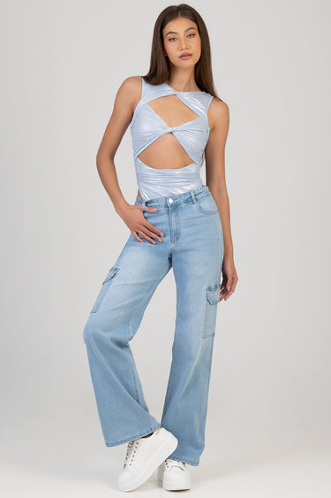 model wearing light wash wide leg jeans with cargo pockets and white sneakers, paired with a metallic blue cutout top