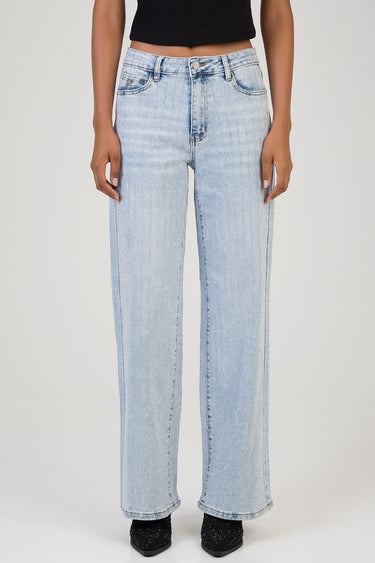 woman wearing light wash wide leg jeans with subtle glitter stripes and a black top