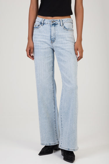 woman wearing light blue wide leg jeans with subtle vertical glittery stripes