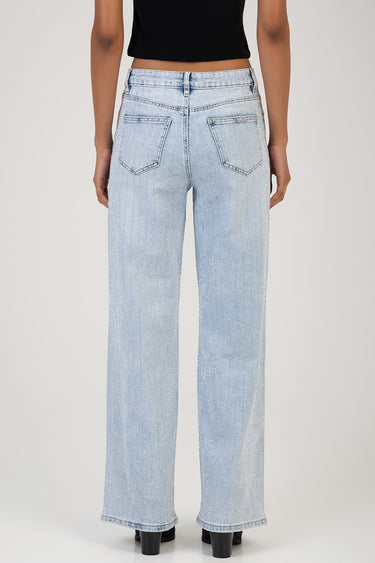 back view of a person wearing light wash wide leg jeans with vertical silver glitter stripes and two back pockets