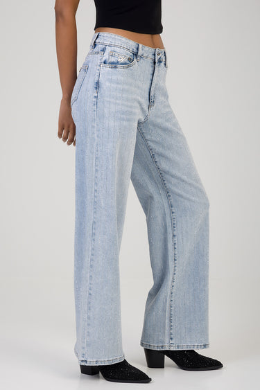 woman wearing light wash wide leg jeans with glitter stripe details, high waist, pockets, paired with a black crop top and