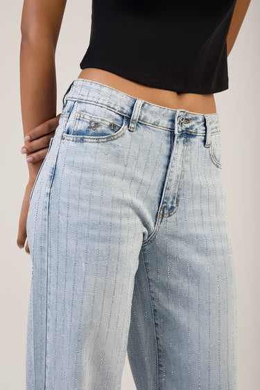 woman wearing light wash wide leg jeans with vertical pinstripe detailing and a black cropped top from Blue Jean Traders