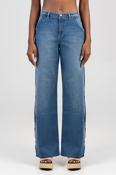 woman wearing blue wide leg jeans with light wash and white side piping