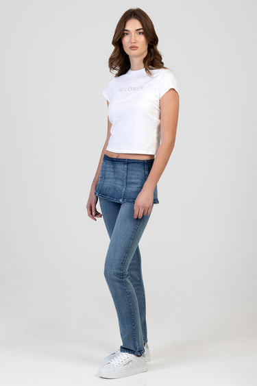 model wearing blue jeans with a layered denim peplum overlayer and a white cropped t shirt