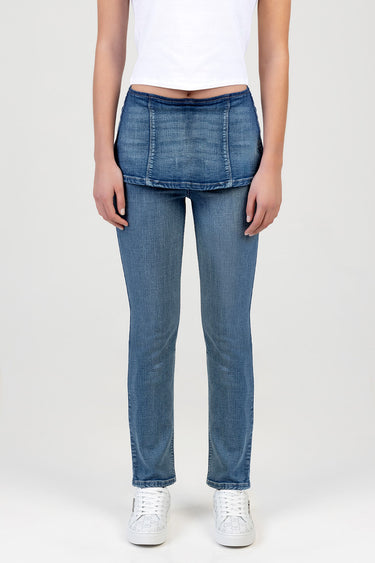 model wearing blue stove pipe jeans with light wash and layered front panel by Blue Jean Traders, with a white cropped top