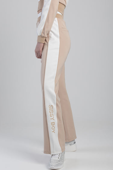 side view of beige track pants with white side stripe and Sissy Boy logo down the leg