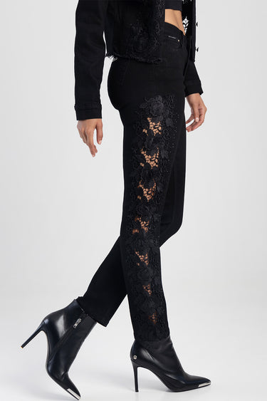 black straight jeans with floral lace panels along the outer leg, paired with black heeled boots