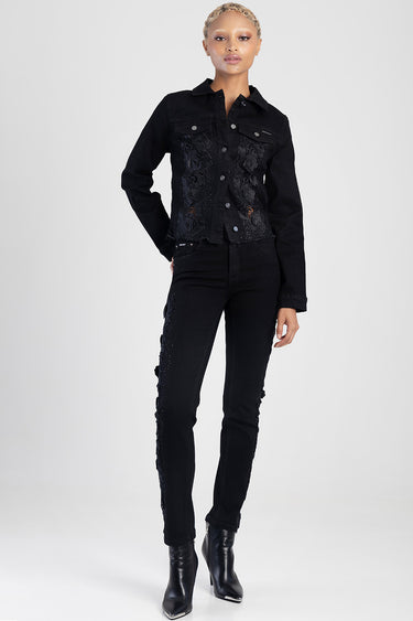 woman standing in black straight jeans with lace trim along the sides, paired with a black lace denim jacket and black