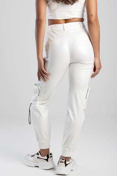 woman in white cargo pants by Blue Jean Traders, back view with zippered pockets on thighs, cinched cuffs and sneakers