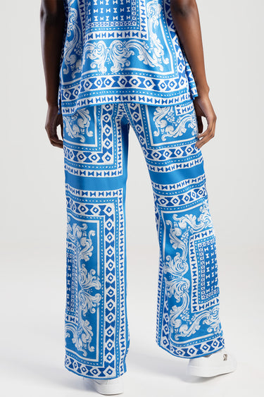 blue jean traders trousers with blue and white ornate geometric and scroll pattern, wide leg fit