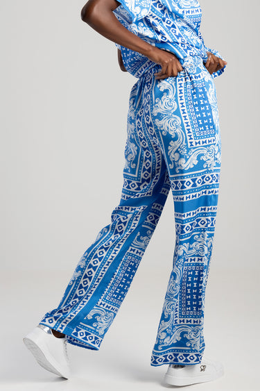 blue jean traders trousers with bold blue and white geometric pattern worn by a model with white sneakers