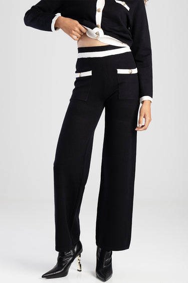 black knit pants with white waistband and pocket trim and gold buttons, wide leg